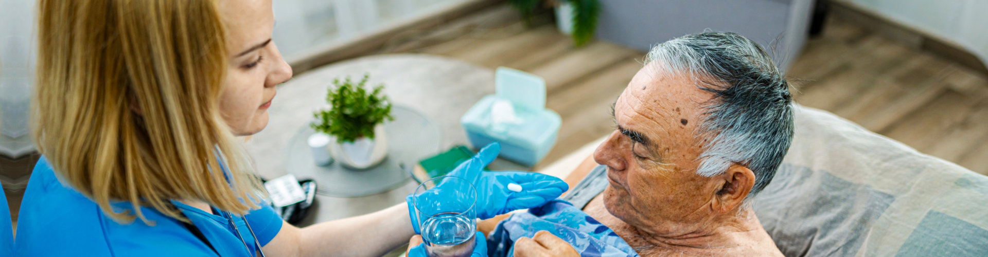caregiver assisting an elder man